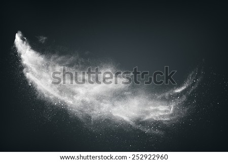 Abstract design of white powder cloud against dark background Royalty-Free Stock Photo #252922960