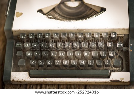 vintage typewriter and flower on the wood desk in vintage color tone