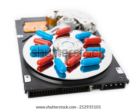 Pills on computer hard drive - concept technology background