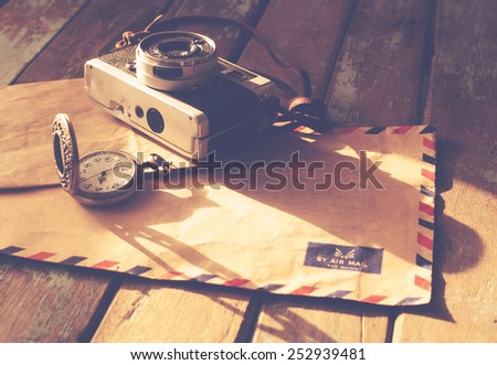 Vintage travel background, old film camera ,antique watches and airmail letter on wood table, instagram effect filter Royalty-Free Stock Photo #252939481
