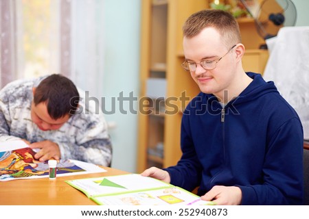 young adult man engages in self study, in rehabilitation center Royalty-Free Stock Photo #252940873