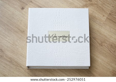 Wedding photo book with leather cover and metal shield.