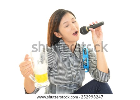 Woman Singing Karaoke with Beer