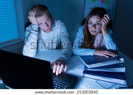 Horizontal view of tired employees during overtime