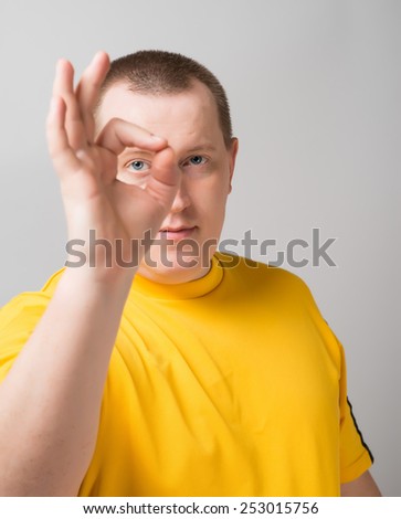 Portrait of funny man showing OK gesture with hands