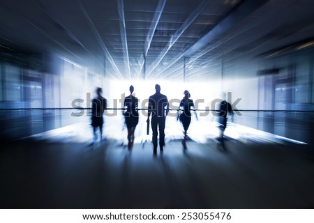 Several silhouettes of businesspeople interacting office background