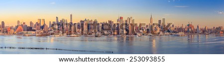 New York City with skyscrapers illuminated over Hudson River panorama
