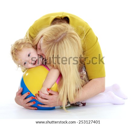 very gentle mother kisses her cute little daughter.Isolated on white.