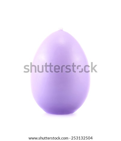 Egg shaped lilac colored wax candle isolated over the white background