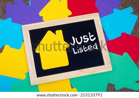 Yellow home sign on the blackboard: Real Estate Concept, Just listed