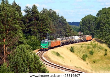 Freight train hauled by the diesel locomotive is passing its route
