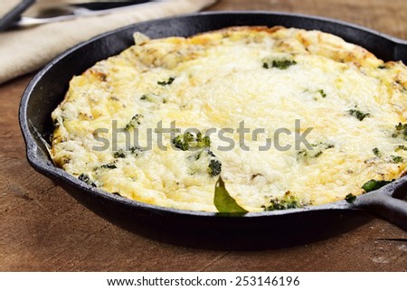 Fresh golden, broccoli, mushroom and spinach frittata with shallow depth of field.