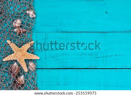 Blank rustic antique teal blue aged wooden sign background with fish net border, seashells and one gold starfish; beach sign with painted copy space