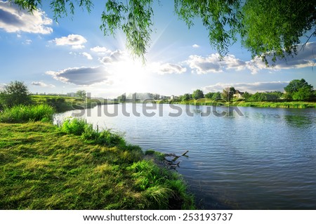 Sunny day on a calm river in summer Royalty-Free Stock Photo #253193737