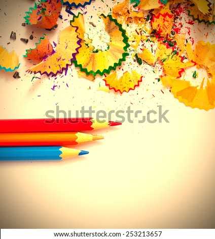 colored pencils and shavings on white background with copy space. instagram image retro style