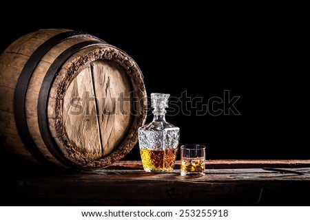 Glass of fine whisky in the distillery basement Royalty-Free Stock Photo #253255918