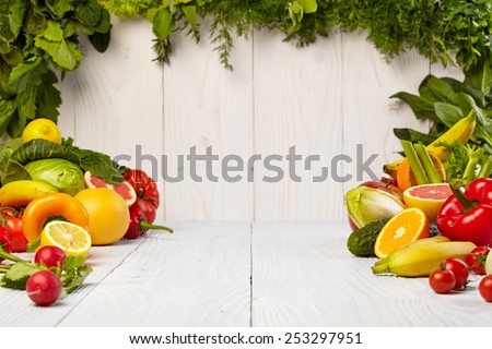 Fruit and vegetable borders Fruit and vegetable borders on wood table Royalty-Free Stock Photo #253297951