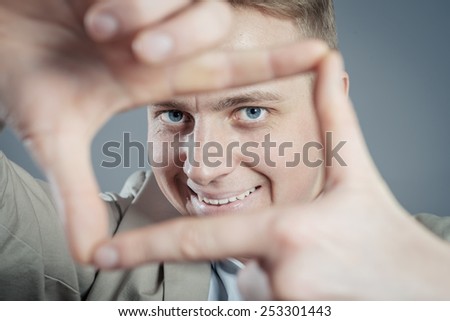man is framing with his hands