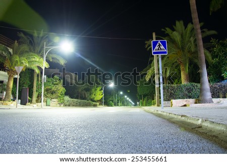 Crosswalk. Highway with lanterns at night.