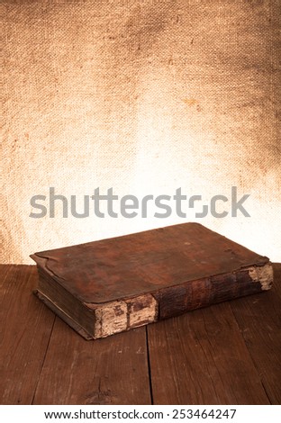 Ancient book on the old wooden table.
