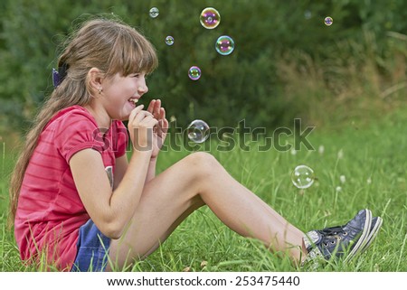 View of a young girl sitting on the grass
