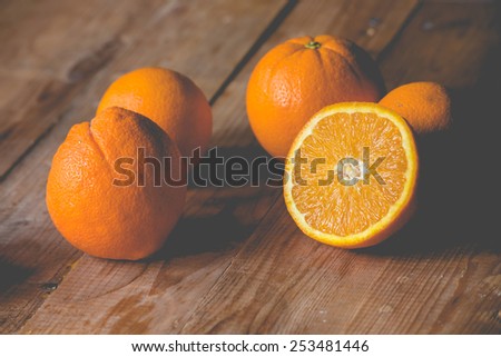 Fresh oranges on wooden table. Toned picture