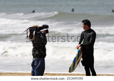 cameraman filming on the beach