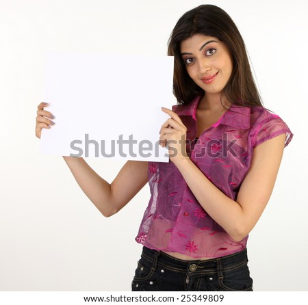 young girl in pink dress holding white board