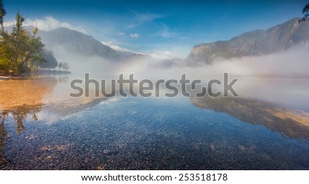Foggy summer morning on the Bohinj lake in Triglav national park Slovenia, Julian Alps, Europe.