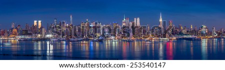 New York City with skyscrapers illuminated over Hudson River panorama