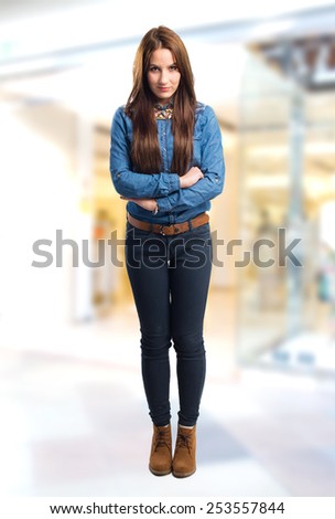 Trendy young woman looking serious. Over shopping center background