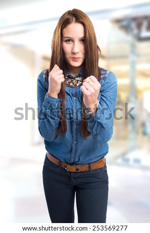 Trendy young woman ready to fight. Over shopping centre background