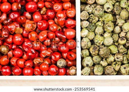 Spices in a wooden box: green and red pepper