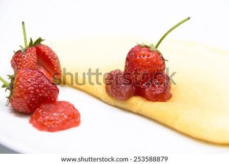 Strawberry pancake on white disk