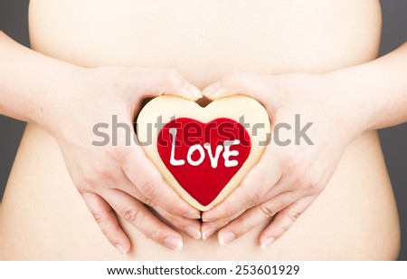 woman's body part,belly.with hand holding love heart,healthcare woman concept.
