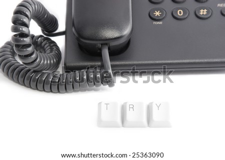 Black office phone and TRY sign