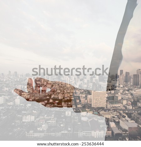 Double exposure of businessman hand and city background