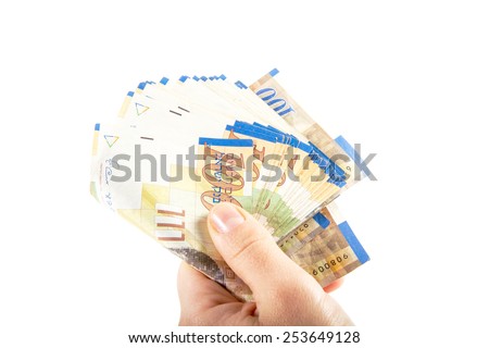 A female hand holding One hundred shekel bank notes against white background. Concept photo of money, banking ,currency and foreign exchange rates.