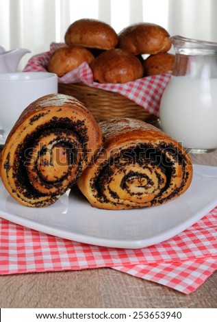 Freshly baked rolls with poppy seeds on a plate napkins