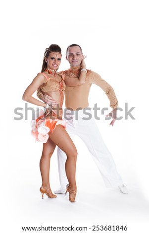 Dancing young couple on a white background. Passionate salsa dancers