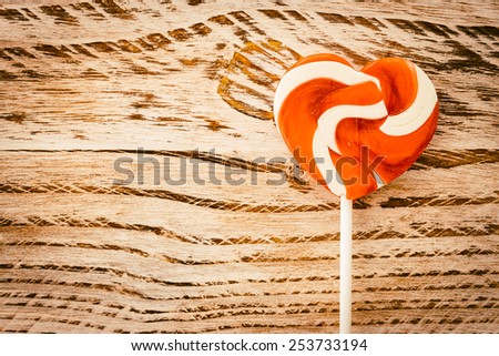 Heart lollipop candy on wood background - Vintage effect style pictures