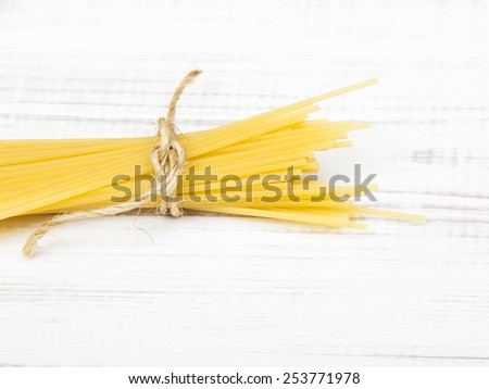 portion of dried spaghetti on white wooden table
