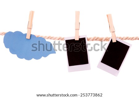 instant photographs and cloud shape hanging on a rope clothesline isolated on white