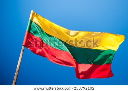 Flag of Lithuania over blue sky background