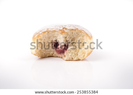 Fresh bitten donut with jam isolated