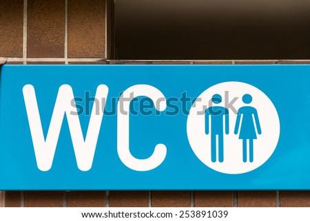 A blue WC water closet sign.