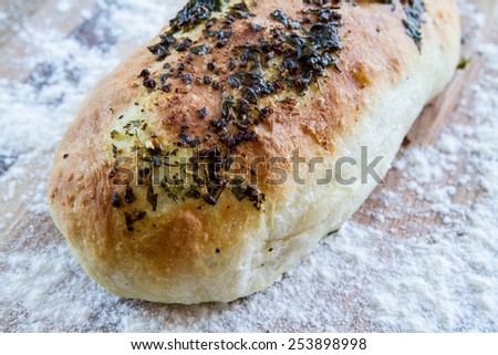 Typical italian Bread with herbs, garlic, olive oil, parsley, basil and cheese
