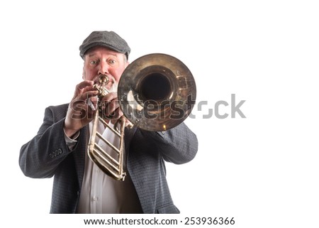 A man playing a vintage silver valve trombone isolated on a white background 