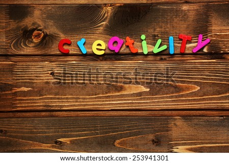 Word creativity on wooden background