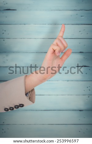 Businesswoman pointing against wooden planks